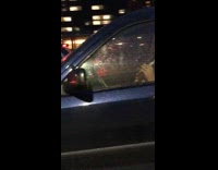 Guy plays clarinet instrument blue car freeway 