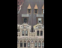 Guy running across building roof