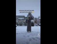 Guy walks outside into snow in robe and throws head scarf on ground
