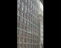 Water from hose seen spraying from higher floor 
