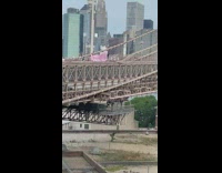 Woman in pink dress on the Brooklyn Bridge