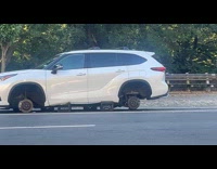 Car on roadside with missing tires