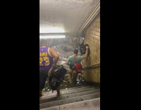 People wading through flooded subway