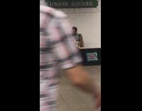 Guy plays electric guitar with one arm, other arm amputated, subway station