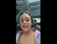 Girl sitting in car lifted getting oil change 