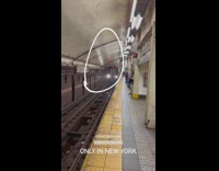 black iphone sitting on subway tracks train passes