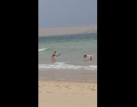 White bikini girl stands in ocean dances 