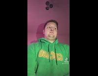 Guy green hoodie nose ring eats marshmallow