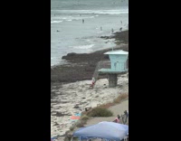 Man lifeguard poses by the lifeguard house