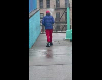 Guy with trash bags tied around shoes to protect from the rain
