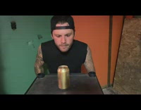 Guy slides under garage door shotguns beer