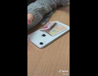 Woman shows her fake camera cover on old iphone makes it look new