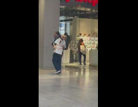 Guy carries ET doll through train station