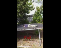Boy in blue shirt does flip on trampoline lands on shoulder