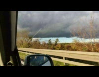 Large grey cloud car green yellow trees