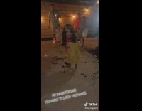 Little girl starts hitting pinata with her hands 