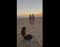 Couple kissed on the beach with helicopter passes by