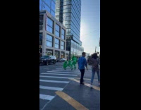 Four women green suit dances at crosswalk