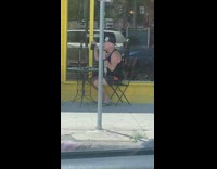 Man black tank top sings with coffee and nose accessory