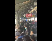 Very crowded train station people wait for train