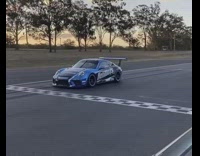 Blue helimods race car drives around track 