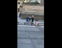 Three girls tiktok dance together outside bench 