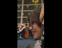 Guy on phone in funny arm position 