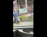 Man stands on side of road with a watermelon on head, Jean Michel Basquiat, David Hammons, Black cherokee sign