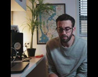 thong song grey shirt guy white desk