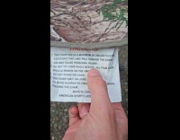 Man shows warning label on 3 legged chair