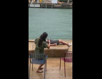 Black dress girl lays back rain river