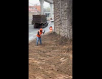 Construction worker tries to hit rat with stop sign