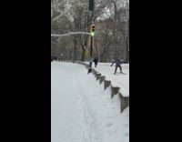 Guy uses snow shoes to walk through snowy area 