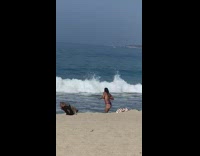 Woman cap purple bikini dance on beach
