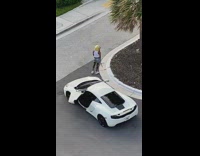 Girl films herself in front of car in street