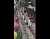 Women in white dresses on train tracks picture