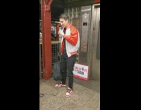 Guy performs stand up comedy subway platform 
