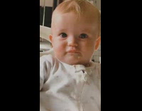 Baby hits slaps white highchair tray 