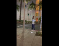 Man in shiny coat livestreams beside his car