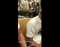 Man uses nail filer on hand palm on subway train white beanie