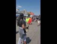 Two women in orange and yellow dress at the docks