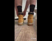 Guy cuts boots so toes stick out 