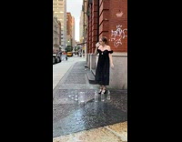 Woman black dress drink spit water street