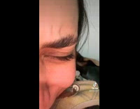Dog trying to bite womans face while cuddling 