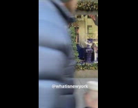 Man wears Christmas tree and disguises himself on the sidewalk