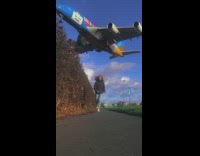 Woman films herself as she runs on the sidewalk 