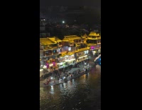 Town with bridge lights up at night