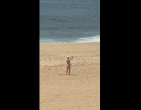 Man pink briefs shaka sign selfie beach