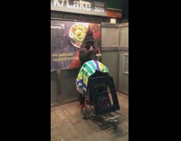 man playing music green blue towel on wheel chair