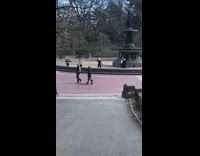 Ladies Take Exercise Class Inside Park Fountain 